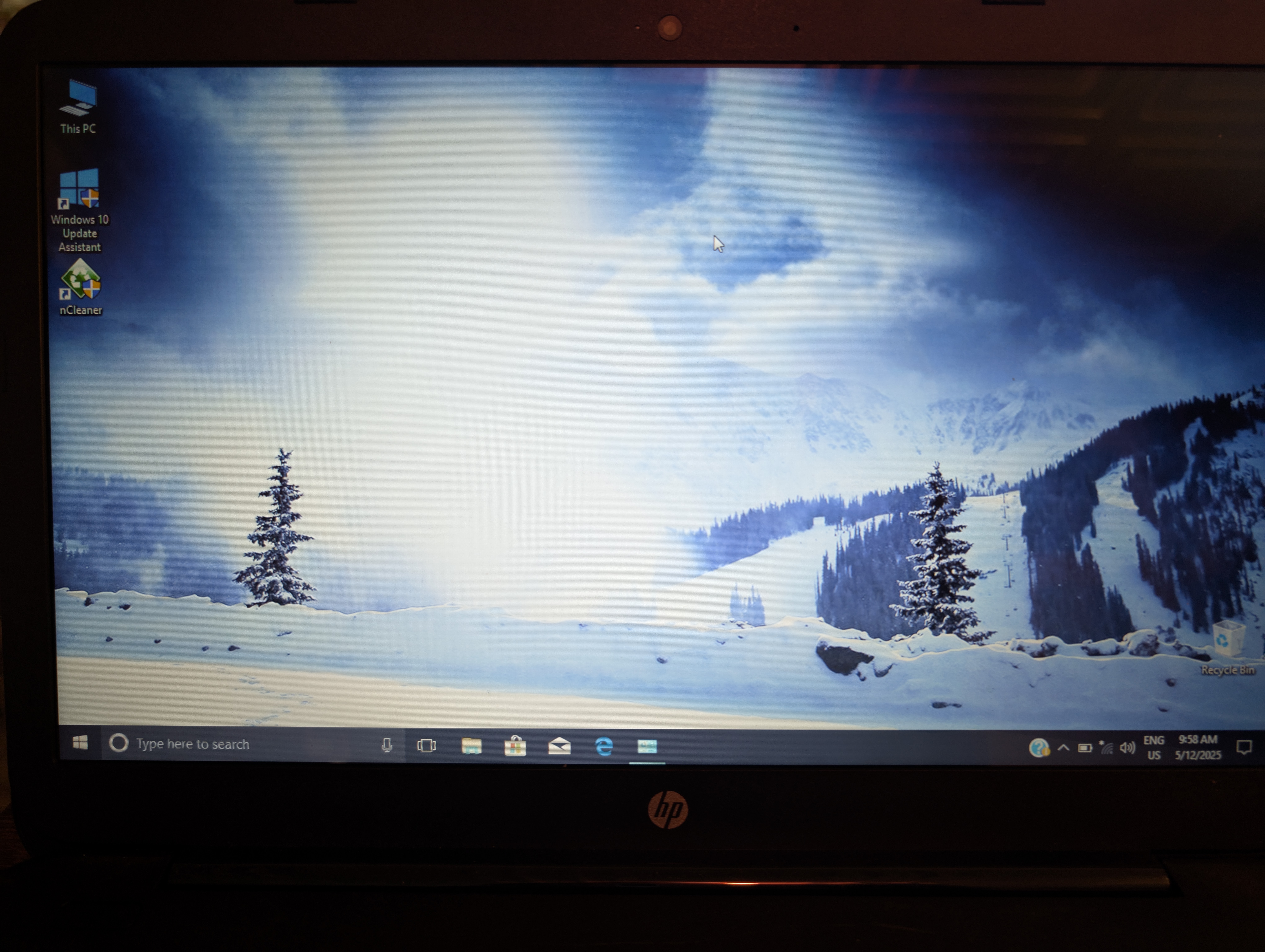 A computer desktop with a few icons and a large snowy mountain wallpaper